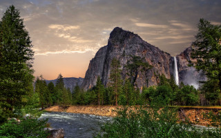 Waterfall forest river cloudy sunset - a waterfall free wallpaper for desktop