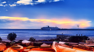 Beach umbrella chairs boat sunset - the water near a beach free wallpaper