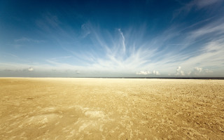 Sandy beach blue sky clouds - a few footprint free wallpaper