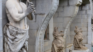 Statue man staff arches columns - grotesque free wallpaper