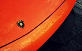 Red car black emblem brick - a close up free wallpaper