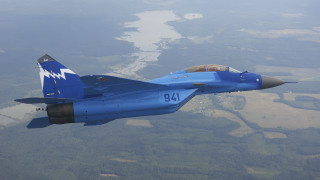 Blue fighter jet flying over - blue sky free wallpaper