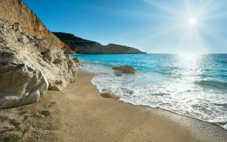 Sandy beach cliff water sunshine - a sandy beach free wallpaper
