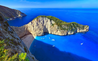 Large rock formation water boats - beautiful landscape free wallpaper