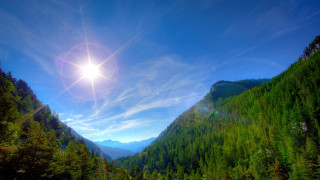 Sun mountain valley trees blue - a sun free wallpaper