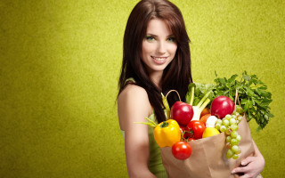 Woman vegetables fruit basket green - a green wall behind her free wallpaper