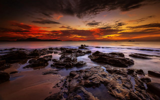 Sunset rocky beach red sky - a sunset over a rocky beach free wallpaper