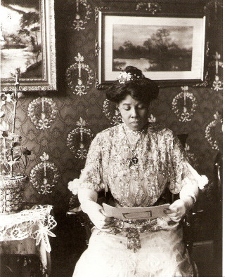 Woman dress chair reading book - betye saar free wallpaper