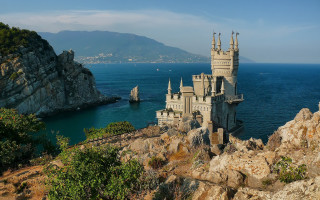 Castle cliff ocean mountains boat - a castle free wallpaper