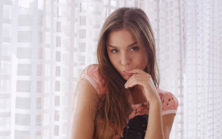 Woman window serious smile brown - front of a window free wallpaper