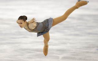 Graceful figure skating arabesque ballet - her leg in the air free wallpaper