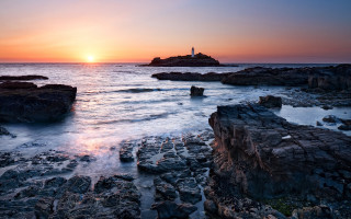 Lighthouse rocky shore sunset water 2 - the background and the water free wallpaper