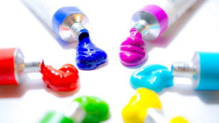 Toothbrushes colorful tube toothpaste action - a white surface free wallpaper