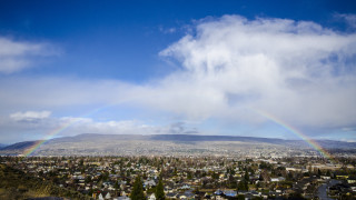 Rainbow city mountains tiltshift lensflare - over a city free wallpaper
