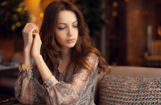 Woman sitting couch hands head 2 - a hand free wallpaper