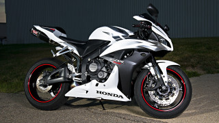 Motorcycle parked street building grass - white background free wallpaper