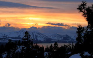 Sunset mountain range trees snow - a sunset view of a mountain range free wallpaper