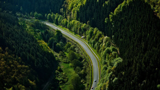 Winding road forest car tiltshift - aerial free wallpaper