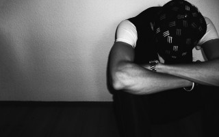 Sad man vest tie crossed - against a wall free wallpaper