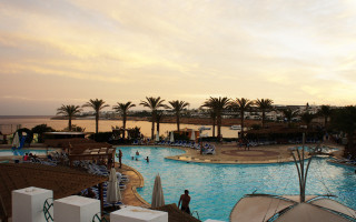 Large pool beach cityscape sunset - a beach in the background free wallpaper