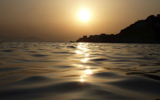 Sunset ocean island buildings matte - a small island in the distance free wallpaper