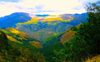 Mountain range trees clouds sunset - a view of a mountain range free wallpaper