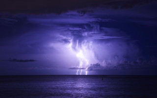 Purple storm ocean boat person - the water below free wallpaper