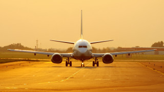 Large jetliner runway sunset backlit - top of an airport runway free wallpaper