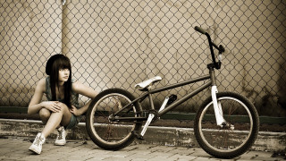Woman bike fence outdoors honeycomb - a woman sitting next free wallpaper