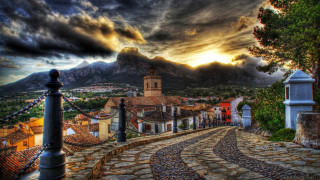 Cobblestone village clocktower mountain landscape - a village free wallpaper