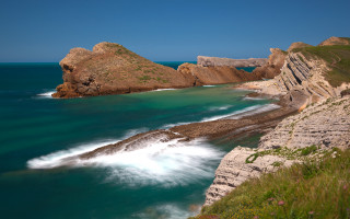 Rocky cliff water grassy hill - a rocky cliff free wallpaper