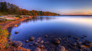 Lake rocks boat sunset clouds - a few cloud free wallpaper