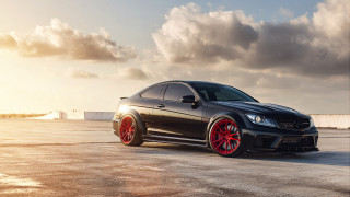 Black car red rims cloudy 3 - a parking lot free wallpaper
