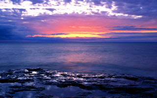 Sunset ocean rock cloudy sky - a sunset over the ocean free wallpaper