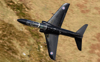 Black fighter jet cobra puzzle - a field of grass and dirt free wallpaper