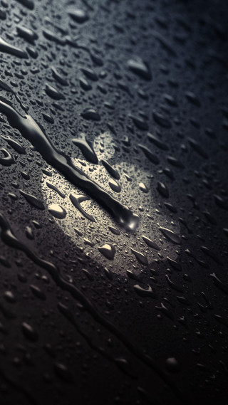 Rain drops closeup black background - a white spot free wallpaper
