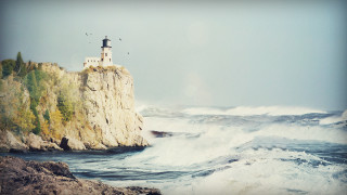 Lighthouse cliff waves birds sunny - a lighthouse free wallpaper