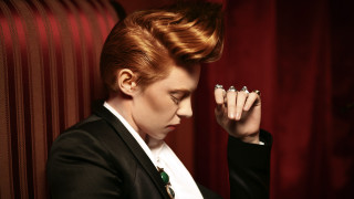 Redhair woman blackjacket handsface lookingdown - a black jacket free wallpaper