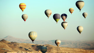 Hot air balloons mountains blue - over a mountain range in the sky free wallpaper