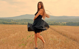 Woman black dress wheat field - her hand and a mountain in the background free wallpaper