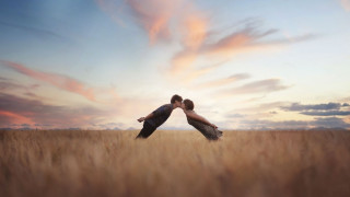 Couple kissing field sunset clouds - a sky background free wallpaper for desktop