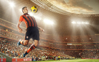 Man kicking soccer stadium cityscape - a soccer ball free wallpaper