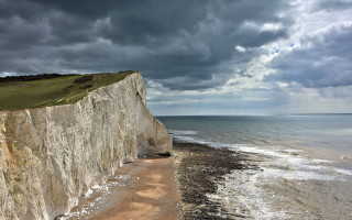 Cliff beach cloudy sky stormy - a dark sky above free wallpaper