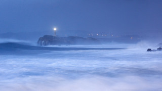 Lighthouse fog water night stormy - a lighthouse in the distance free wallpaper