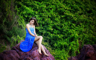 Woman blue dress sitting forest - a forest of trees and bushes free wallpaper