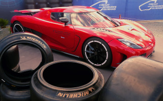 Red sports car tires blue - the ground in front free wallpaper