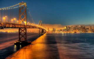Bridge city night lights water - a city in the foreground free wallpaper
