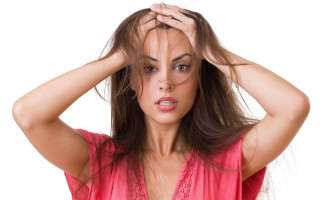 Concerned woman holding hair shock - head and shoulders portrait free wallpaper