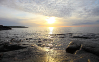 Sunset ocean rocks water island - a small island in the distance free wallpaper