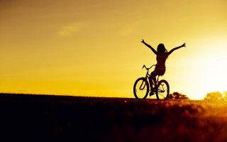 Sunset biker arms outstretched hill - a person riding free wallpaper